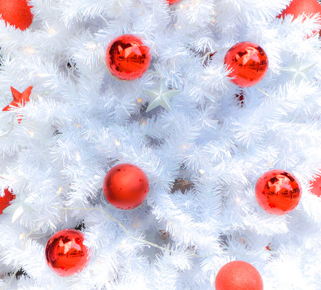 Snow white christmas tree with decoration in redの写真素材