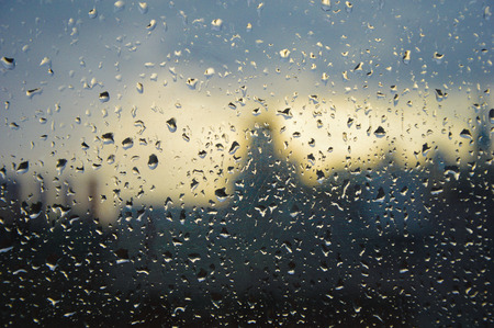 rains decorate a window on a foggy rainy London afternoon