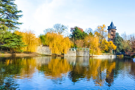 Autumn landscape with colourful trees reflecting in a calm lakeの写真素材