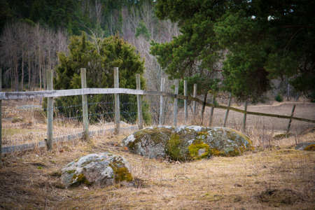 Wooden fence on a field in Swedenの写真素材