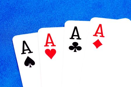 Four ace playing cards in a row