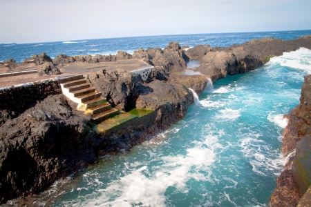 A rocky landscape with alot of water on Tenerife, Spainの写真素材