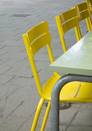 Some yellow chairs on a cafeの写真素材
