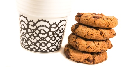 Some cookies lying beside a cup of coffee