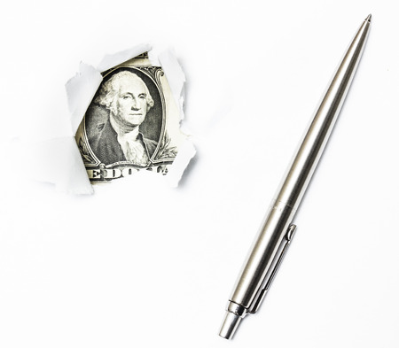 A dollar bill trying to break out from a white paper with a penの写真素材