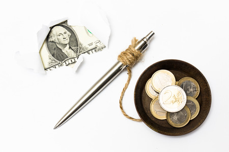 A dollar bill trying to break out from a white paper and are connected with euro moneyの写真素材