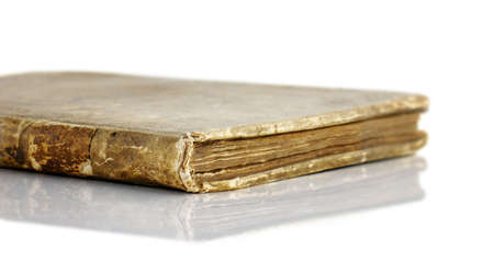 Very old handmade book with leather cover; isolated with reflectionの写真素材