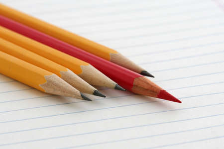 One red and four yellow pencilsの写真素材