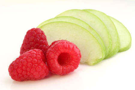 Raspberries and sliced apple. Isolated.