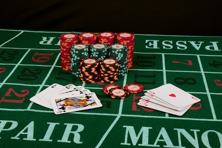 Casino card game showing chips on green cloth backgroundのeditorial素材