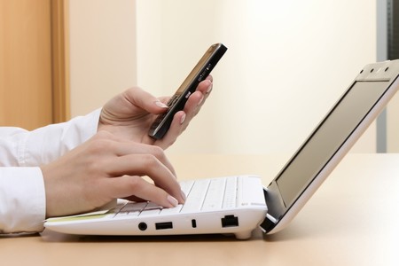 Young girl at office on the workplace makes call.の写真素材