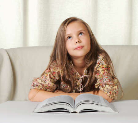 Little girl dreams when reading the bookの写真素材