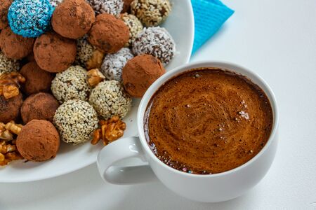truffles with cocoa, coconut and sesame with chocolate and marshmallows and a cup of aromatic...