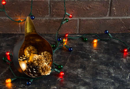 Christmas fabulous composition with an unusual candlestick, golden cones and New Years lights -...