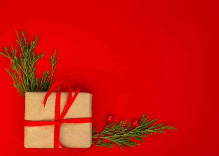 Christmas and New Year card, background - spruce, gifts on a red background, symmetry. Flat lay, copy space, top viewの写真素材