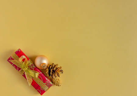 Christmas and New Year greeting card, background - gifts, cones on a yellow, stylish. Flat lay, copy...