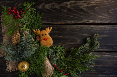 Christmas and New Year compositions on a wooden background, cones, spruce. Cozy. Copy space, flat lay, top viewの写真素材