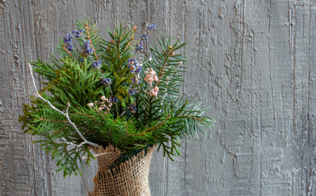 beautiful christmas decor in silvery tones, christmas bouquet, christmas toys on a concrete backgroundの写真素材