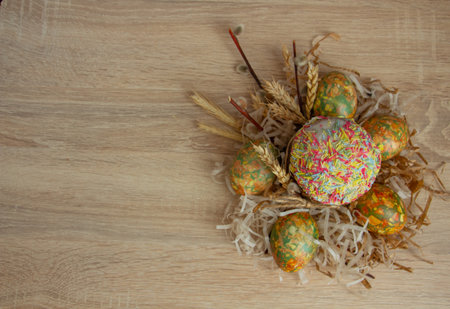 Beautiful Easter composition - colorful eggs, Easter cake, ears of wheat, traditionally elegant.