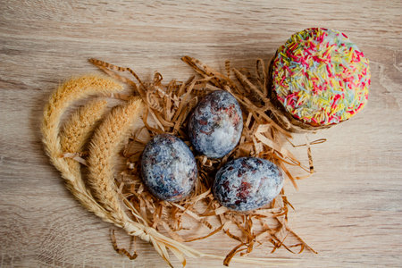 Beautiful Easter composition - colorful eggs, Easter cake, ears of wheat, traditionally elegant.