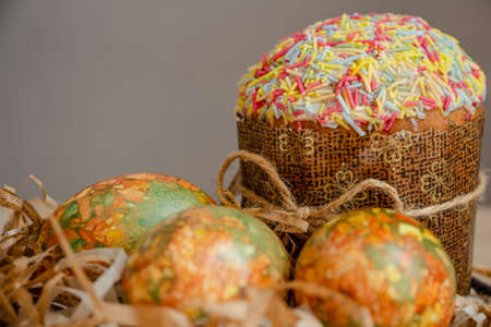 Beautiful Easter composition - colorful eggs, Easter cake, ears of wheat, traditionally elegant.の写真素材