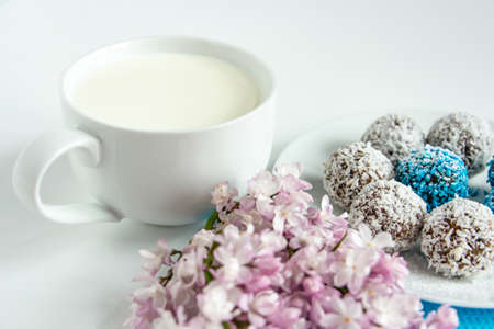 truffles with cocoa, coconut and sesame with chocolate and marshmallows and a cup of fresh milk,...