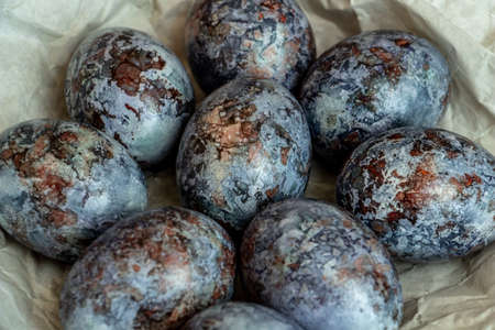 Beautiful Easter composition - colored eggs, similar to marble, ears of wheat, willow branches,...