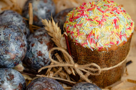 Beautiful Easter composition - colorful eggs, Easter cake, ears of wheat, traditionally elegant.