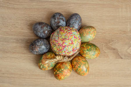 Beautiful Easter composition - colorful eggs, Easter cake, ears of wheat, traditionally elegant.