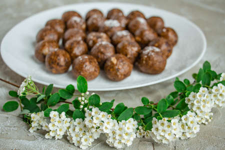 truffles with cocoa, coconut, sesame seeds with chocolate and marshmallows, delicious dessert on a concrete backgroundの写真素材