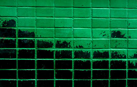 Background from an old wall lined with green and black tiles, copy space, space for textの写真素材