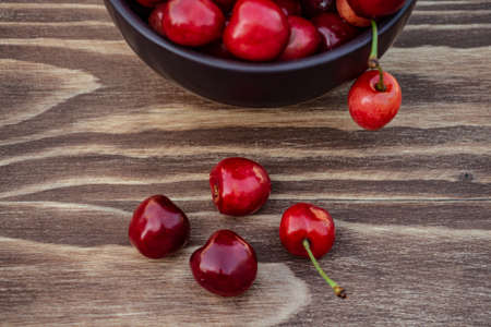 ripe cherries on brown background, delicious appetizing cherriesの写真素材