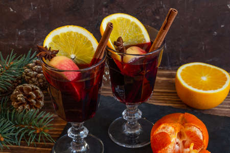 Two glasses of hot mulled wine, spruce branches, citrus fruits, the atmosphere of Christmas and New Year. High quality photoの写真素材