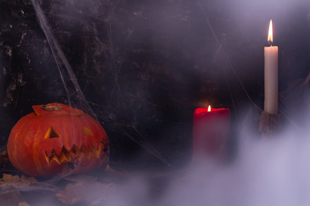 Halloween decorations in smoke, pumpkin, candles, Jacks lantern from pumpkinの写真素材