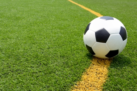 Soccer football field stadium grass line ball background texture light shadow on the grassの写真素材