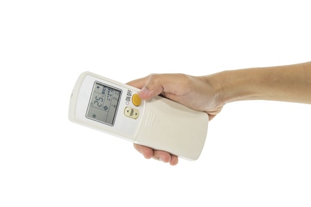 Hand is holding a remote control of air conditioner 25 degrees Celsius only wish clipping pathsの写真素材