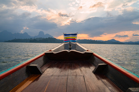 wooden boat with sunset