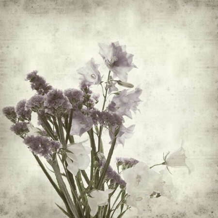textured old paper background with bunch of flowersの写真素材