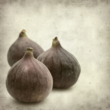 textured old paper background with ripe purple bursa figs fruitの写真素材