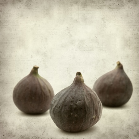 textured old paper background with ripe purple bursa figs fruitの写真素材