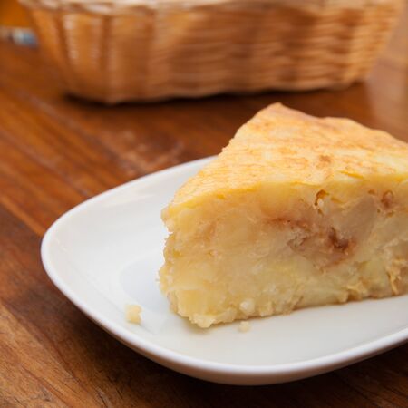 portion of tortilla (Spanish omelette) on a wooden tableの写真素材