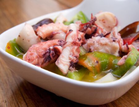 portion of octopus salad on a wooden tableの写真素材