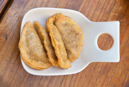 portion of tuna pastries (Empanadas), on a  wooden tableの写真素材