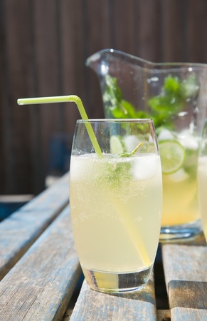 home-made cloudy lemonade with mint and lime; set outside in sunshineの写真素材