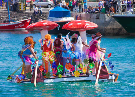 Participants take to water in a variety of unlikely crafts in the port for the yearly  Regata de Achipencos  in Puerto del Rosario, Fuerteventura, Canary Islands   Regata  is a part of yearly carnival events  ACHIPENCO is an acronym of Artilugio Carnavaleのeditorial素材