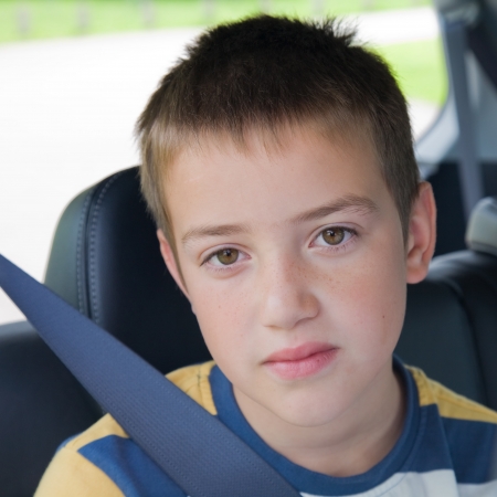boring car journey - cute little boy in a back seat of a carの写真素材