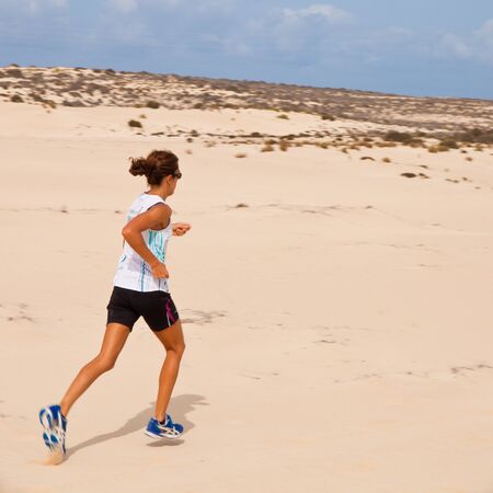 CORRALEJO - OCTOBER 30: Aroa Merino leads and wins the women  race at IIIrd international Fuerteventura half-marathon 30 October, 2011 in Corralejo, Fuerteventura, Spainのeditorial素材