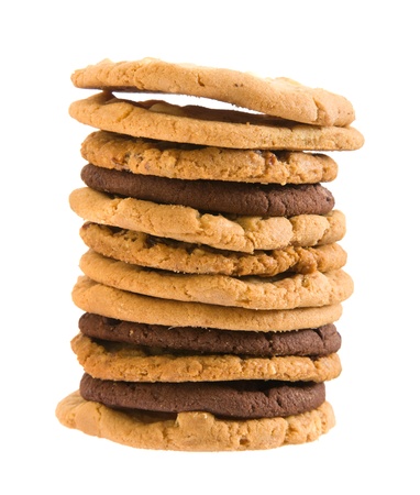 high stack of different types of cookies ; isolated on white background; の写真素材