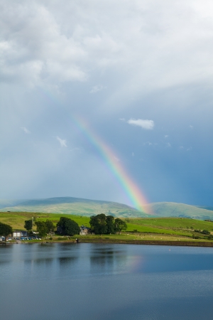 rainbow over a lake, boathouseの写真素材
