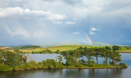 rainbow over a lakeの写真素材